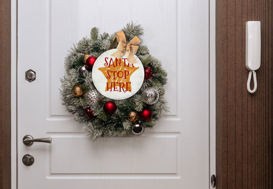 Wall hanging sign looking like celebrity holiday decorations