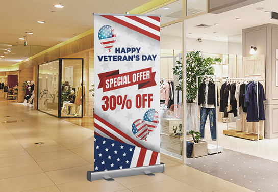 Special in-store sale sign for Veteran’s Day with a congratulatory note and balloons