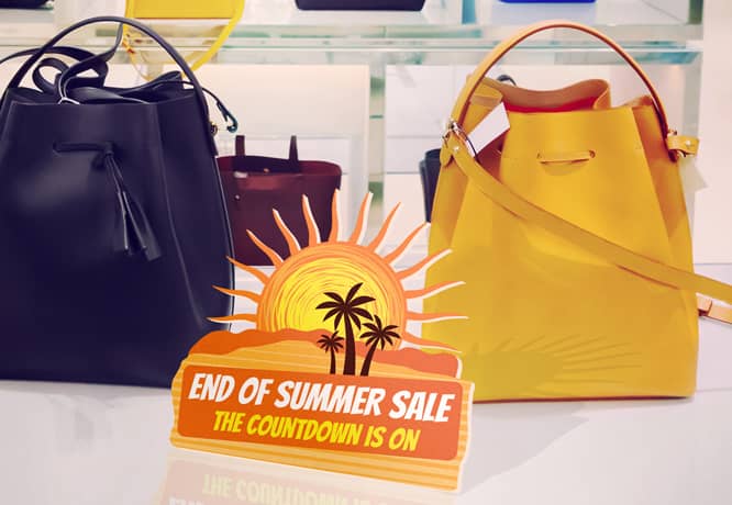 Vibrant end-of-summer sale sign with in-store installation