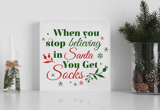 White funny Christmas sign made of wood with a printed quote