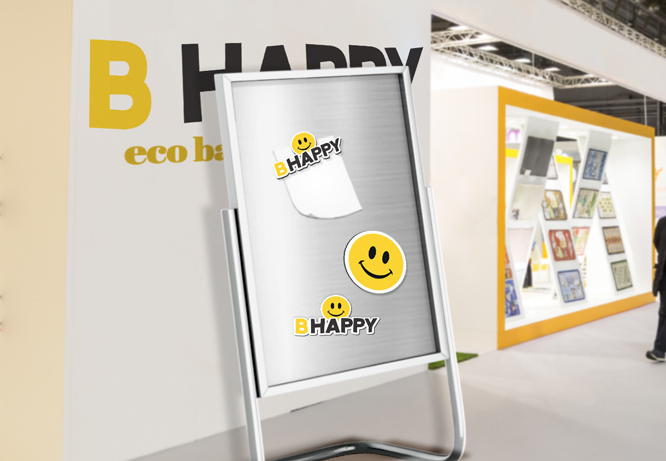 Trade show giveaway magnets in the shape of a smiling emoji and a BHappy note