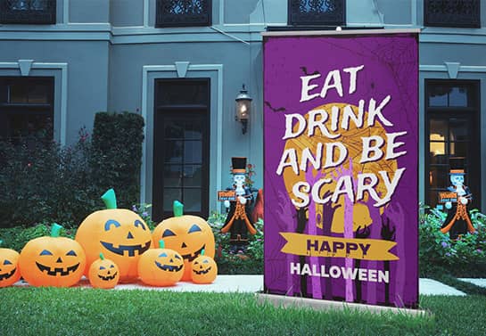 free standing Happy Halloween banner in purple displayed outdoors
