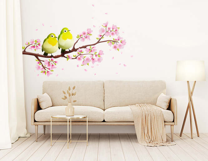 A cute living room wall decal with birds and flowers above a sofa