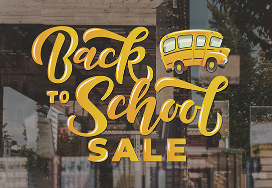 Back to school sale sign depicting a school bus designed for a store window decoration