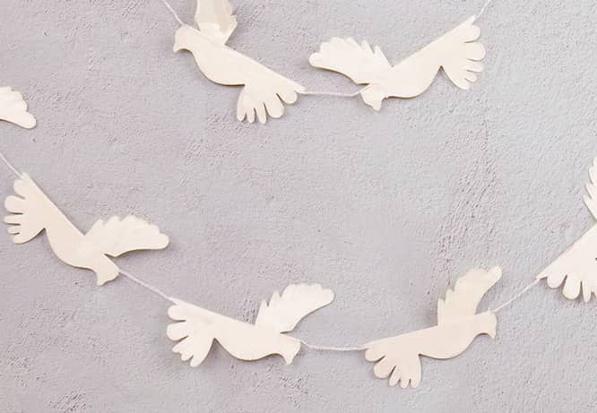 Unique Easter decoration origami doves hanging on a wall of a church