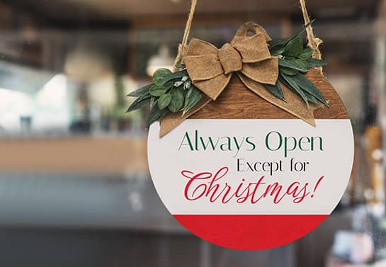 round office closed for Christmas sign with white and red stripes and a ribbon on top