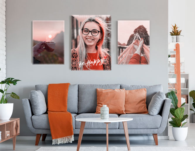 Customized wall art gallery in red hues displaying personal photographs on a living room wall