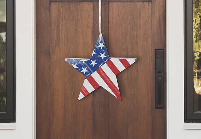 Star-shaped 4th of July decoration idea with US flag colors hanging on a door