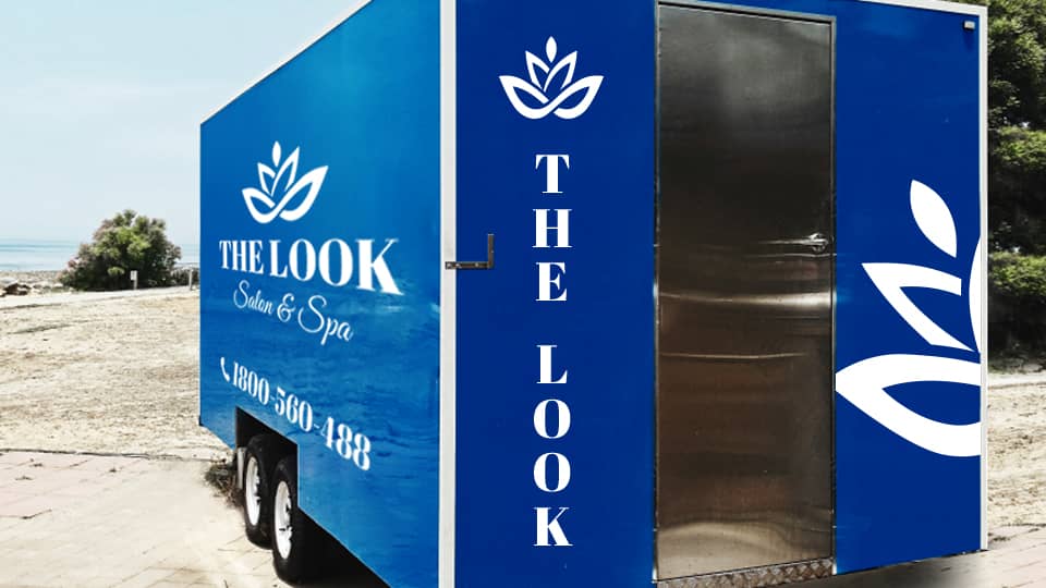 The Look Salon & Spa trailer decals with the brand's logo and contact number