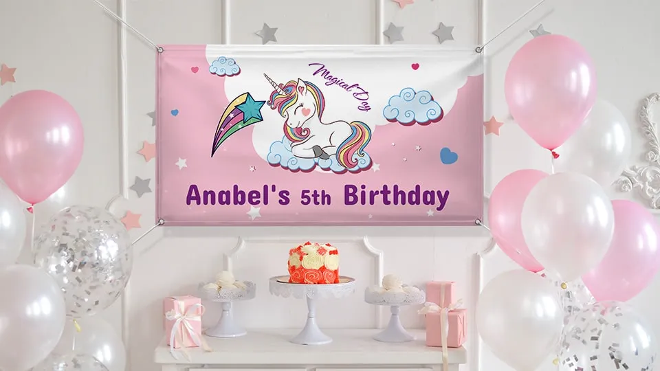 5th birthday banner in pink portraying a cute unicorn hung over the birthday cake table.