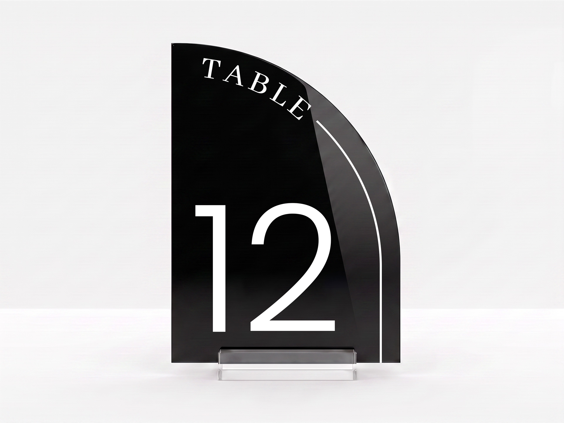 Black arch-shaped acrylic table number printed with Table 12 in white lettering