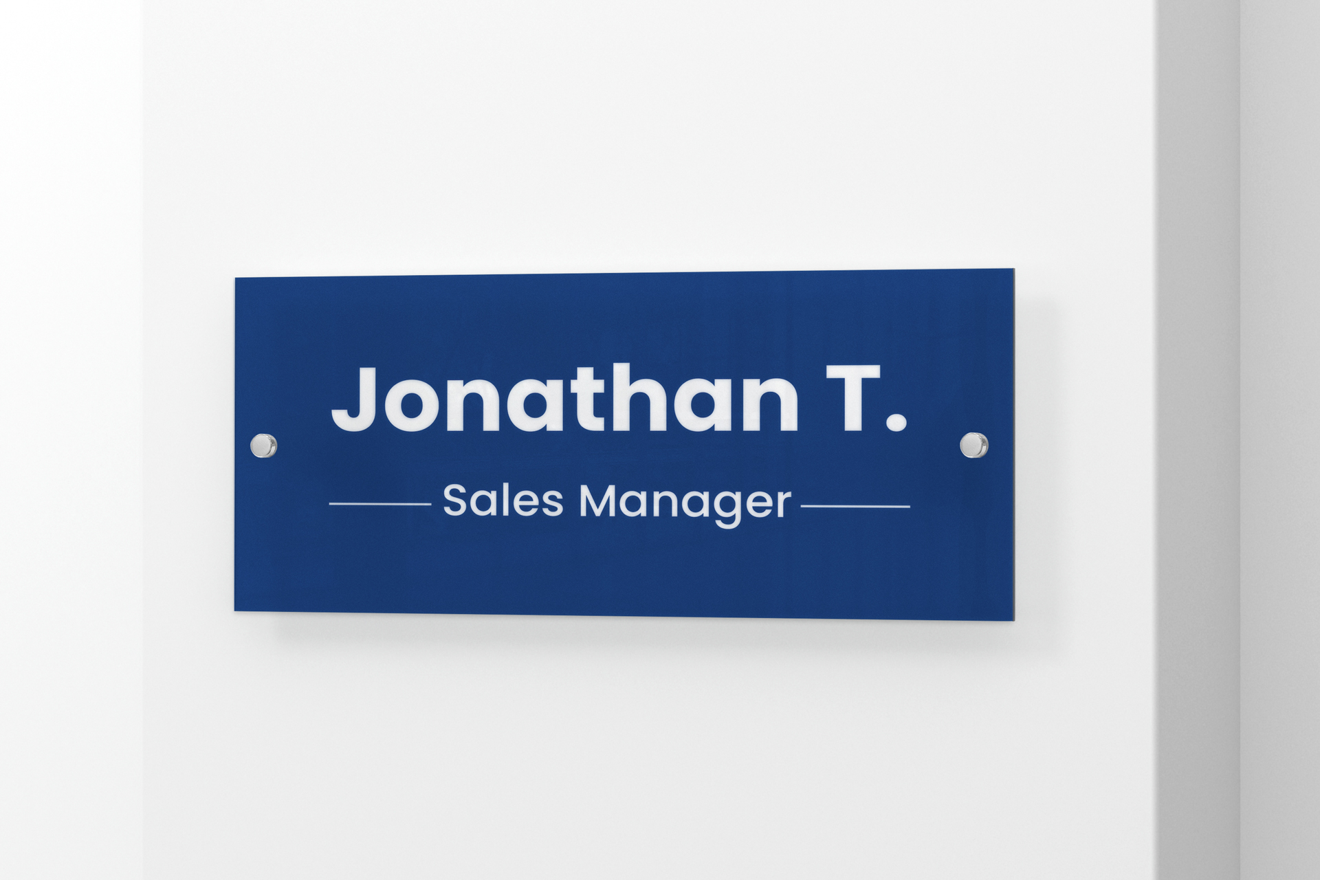 blue acrylic nameplate mounted on an office wall