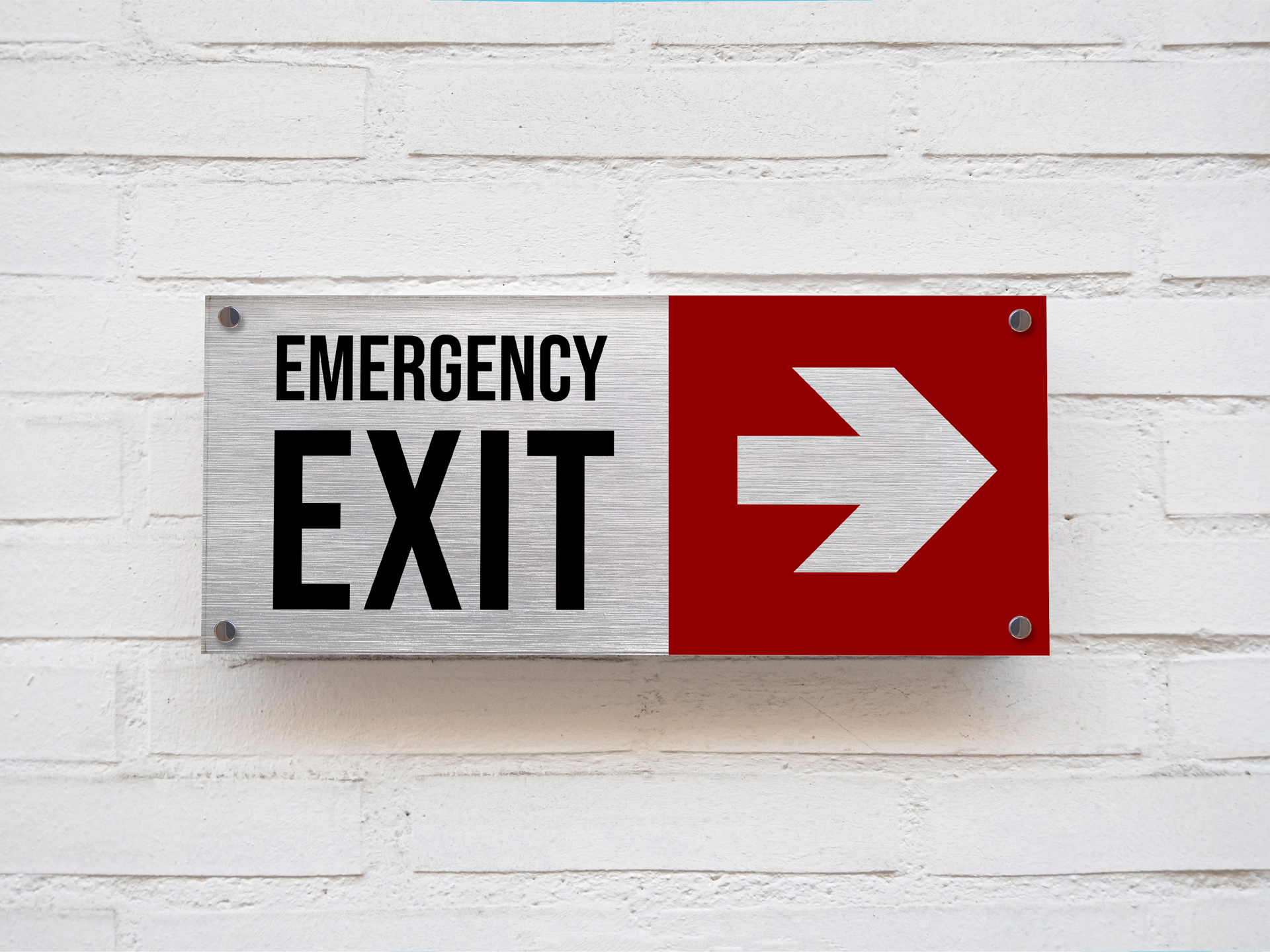 Wayfinding brushed aluminum emergency exit sign with an arrow.