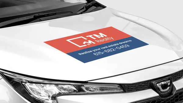 TM Realty car hood decal with branded elements and contact info.