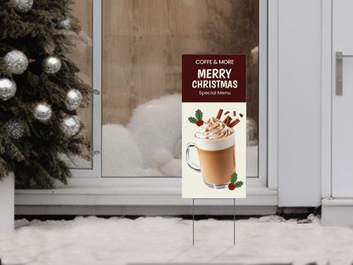 Merry Christmas café yard sign with holiday drink photo and special menu message displayed outside in the snow.