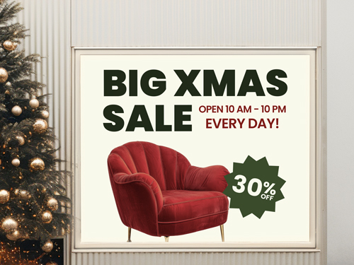 Backlit window decal promoting a big Christmas sale with a red armchair and 30% off message.