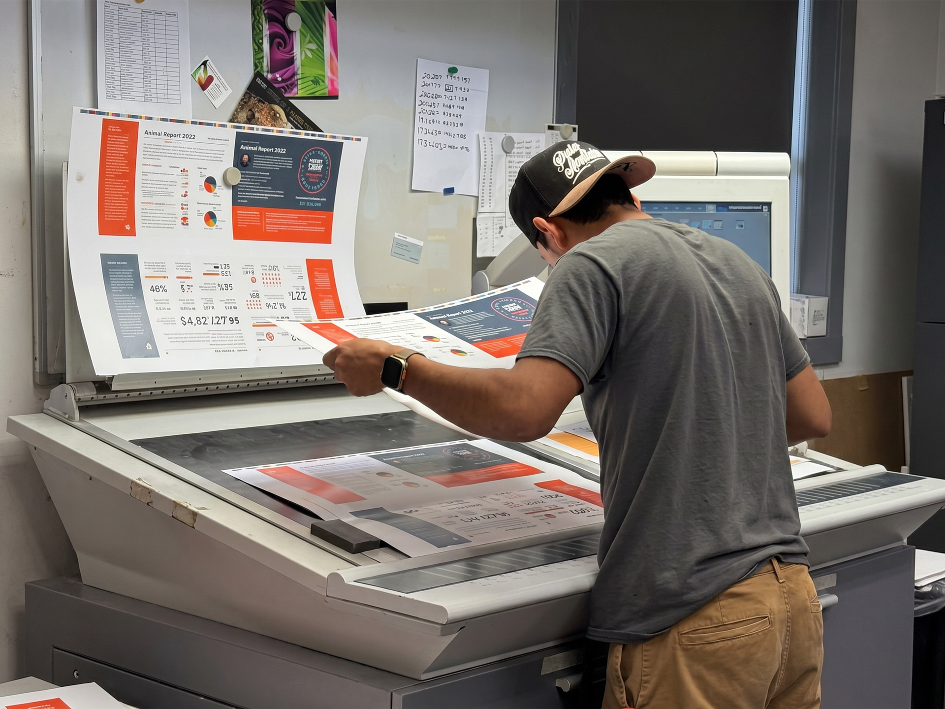 Print specialist inspecting color proofs on a large format printing press