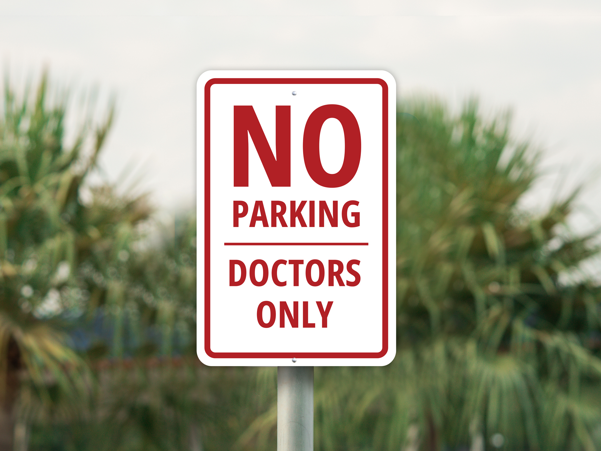 No parking sign reserved for doctors only near medical facility.