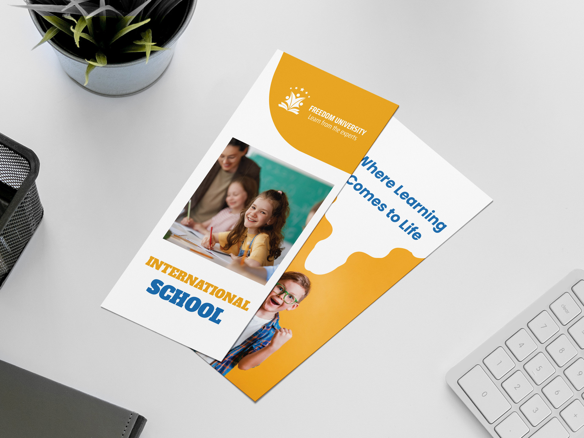 Freedom University International School rack cards on desk with student photos.