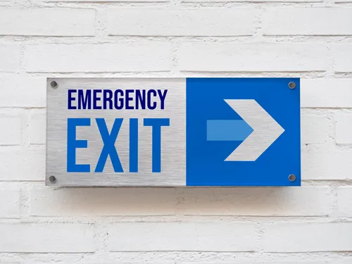 Wayfinding brushed aluminum emergency exit sign with a blue and white arrow.
