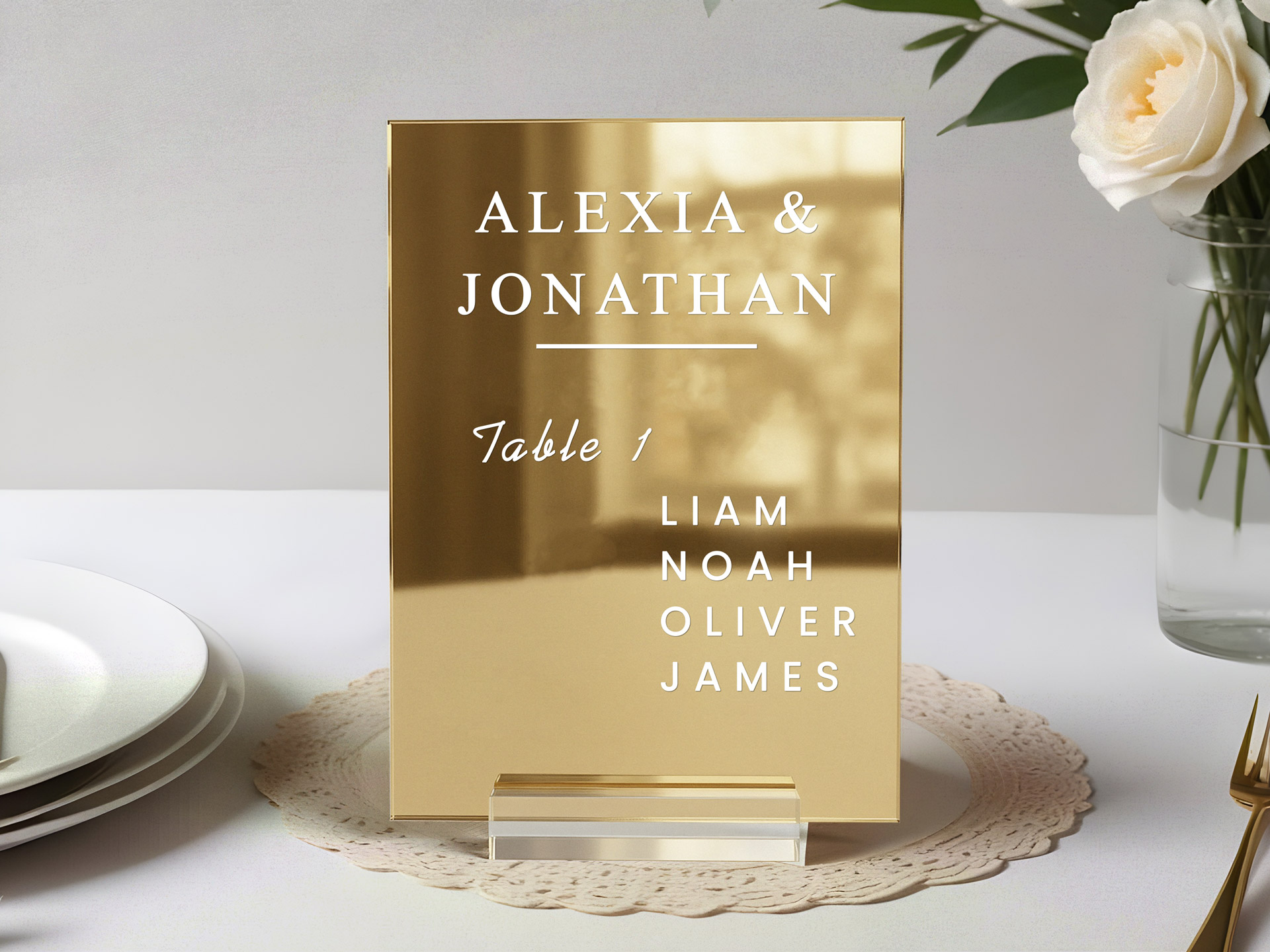 Golden acrylic tabletop sign for a wedding with bride and groom's names.