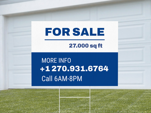 Bold real estate sign promoting a property for sale with contact details.