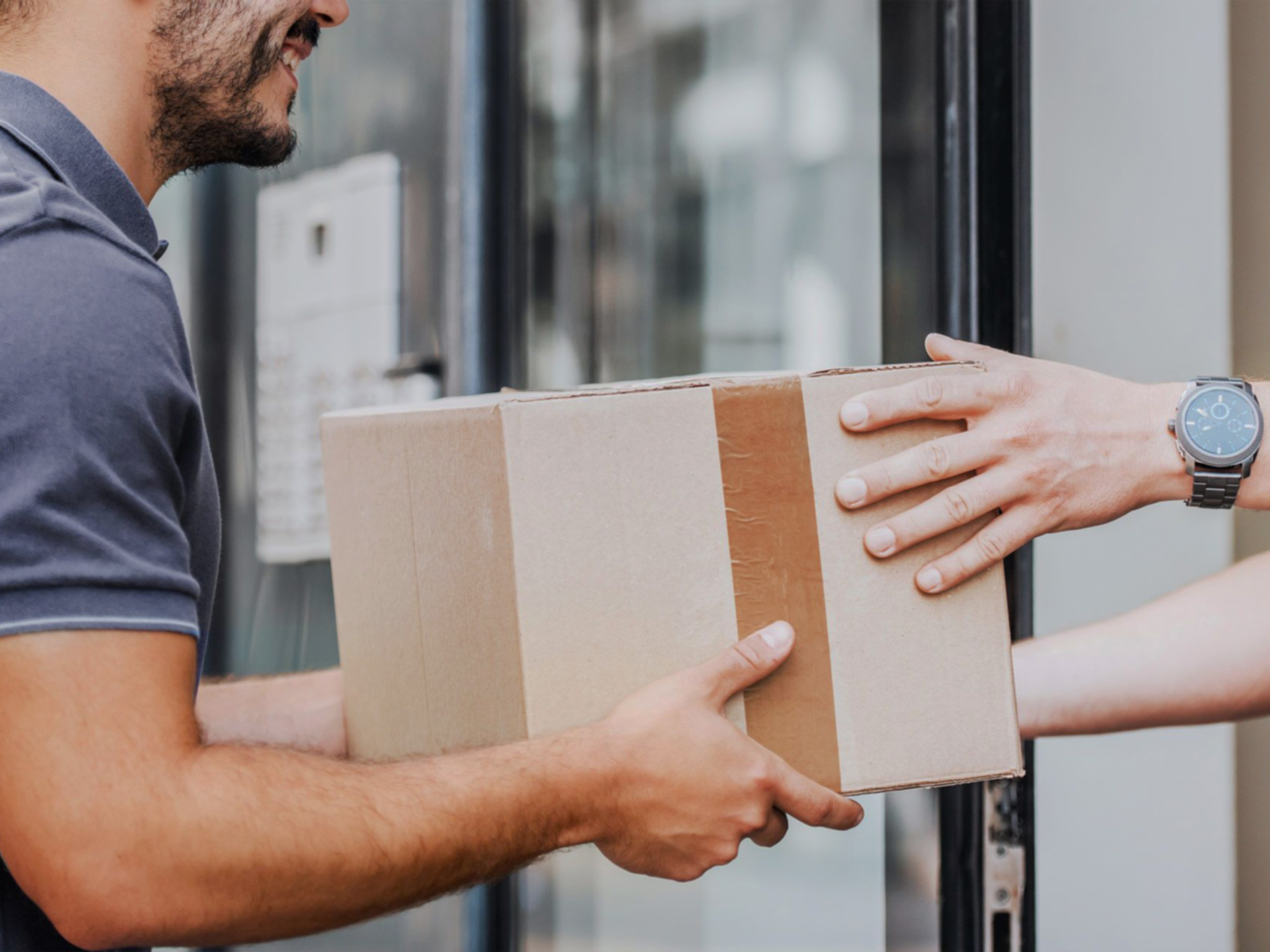 Courier delivering a securely packaged custom sign order to a customer's door