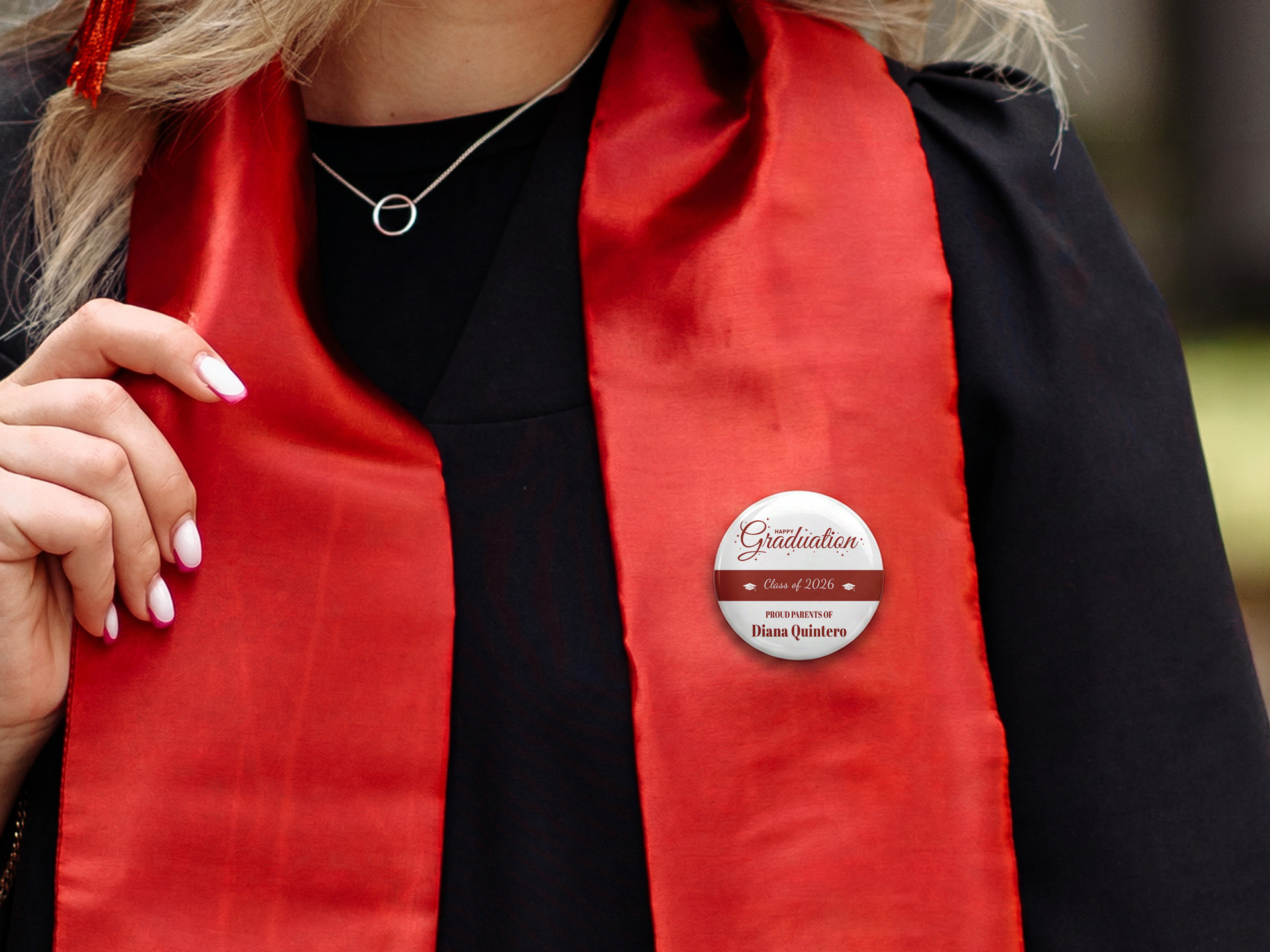 round graduation pinback button attached to a gown