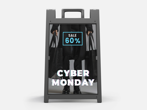 A Cyber Monday A-frame sign showing shopper with bags and holographic text.
