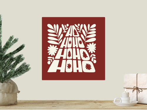 Red square wall decal with stylized “Ho Ho Ho” Christmas tree-shaped typography and decorative leaves.