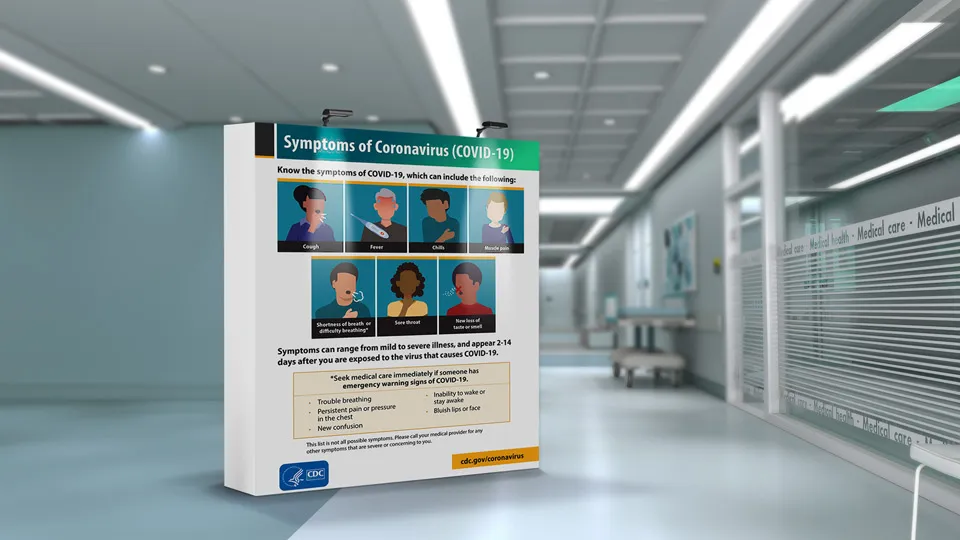 Pop up banner with LEDs warning of Covid 19 symptoms placed in a hospital.