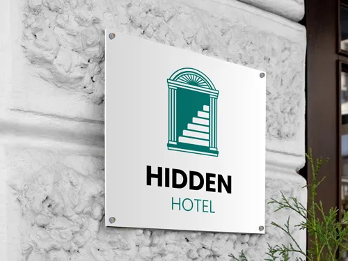 Custom aluminum sign mounted on an exterior hotel wall, featuring a sleek design with logo and text for professional branding.