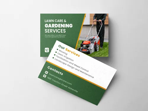 Lawn care business cards with a mowing tractor image, service list and contact details