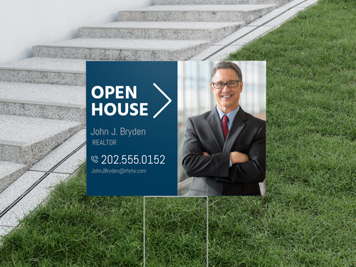 An Open house yard sign with realtor's name and headshot.