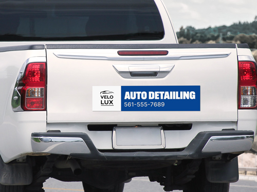Magnetic sign applied to the back of the truck reading Auto Detailing.