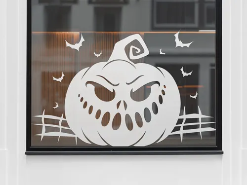 A white Halloween-themed window decal with a mischievous pumpkin face and flying bats. 