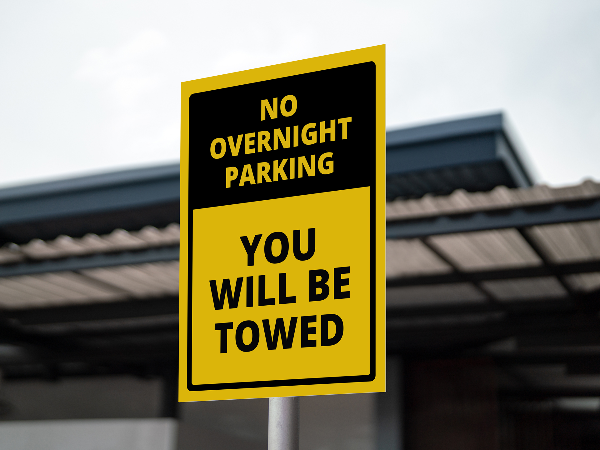 yellow and black no overnight parking tow away sign on a pole