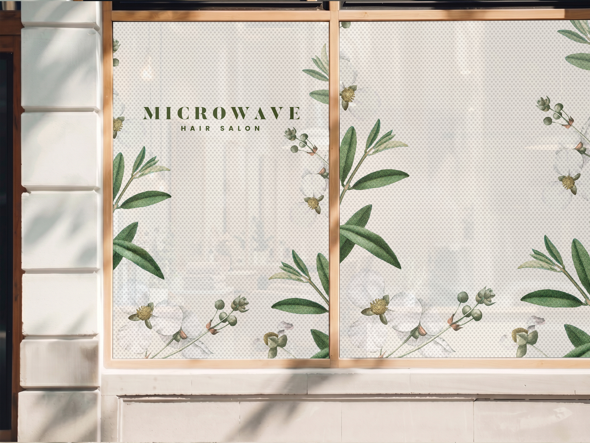 Hair salon window decal printed with perforated material, featuring company name.
