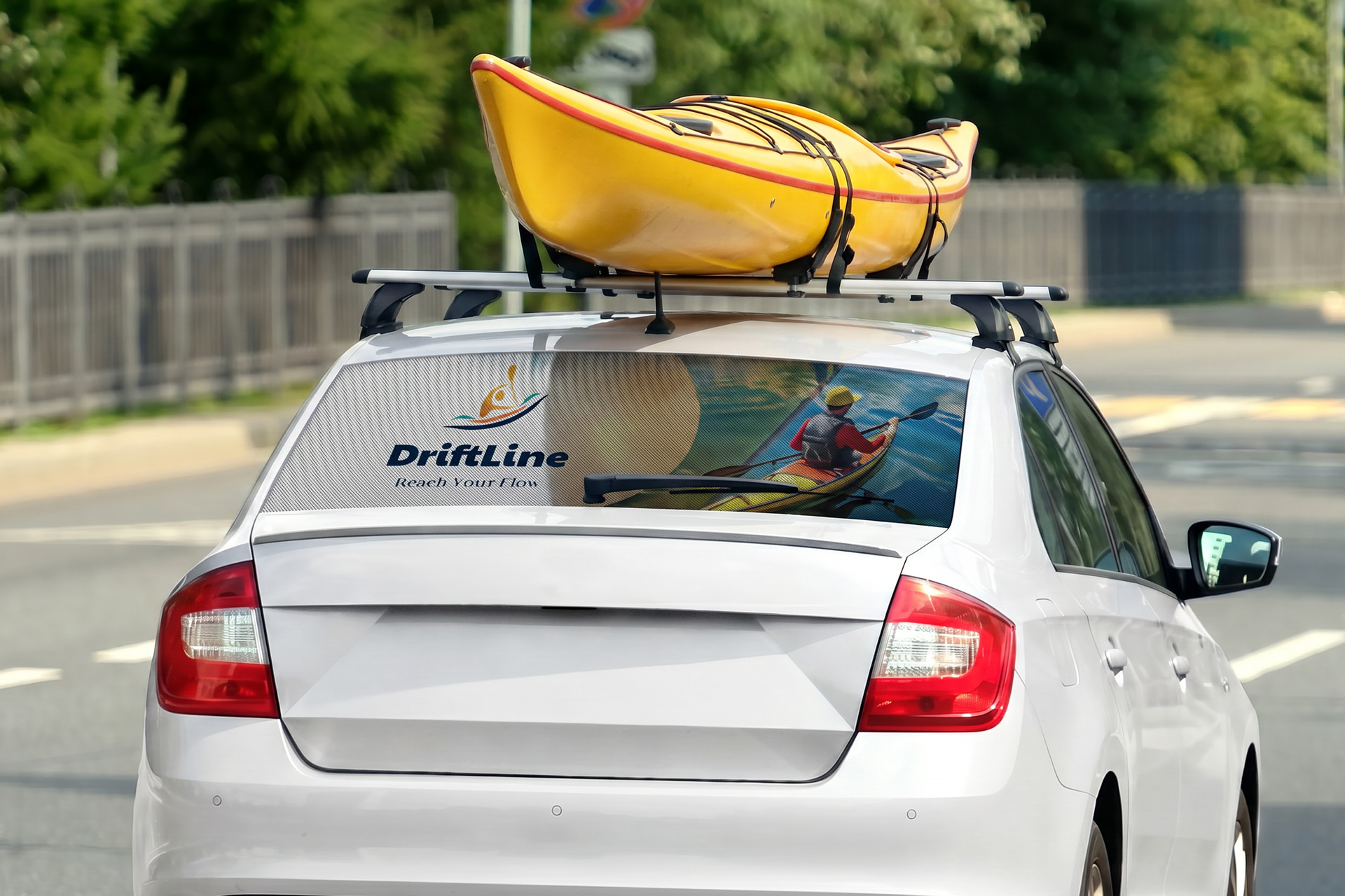 Rear window see through graphics featuring branding elements on a sedan