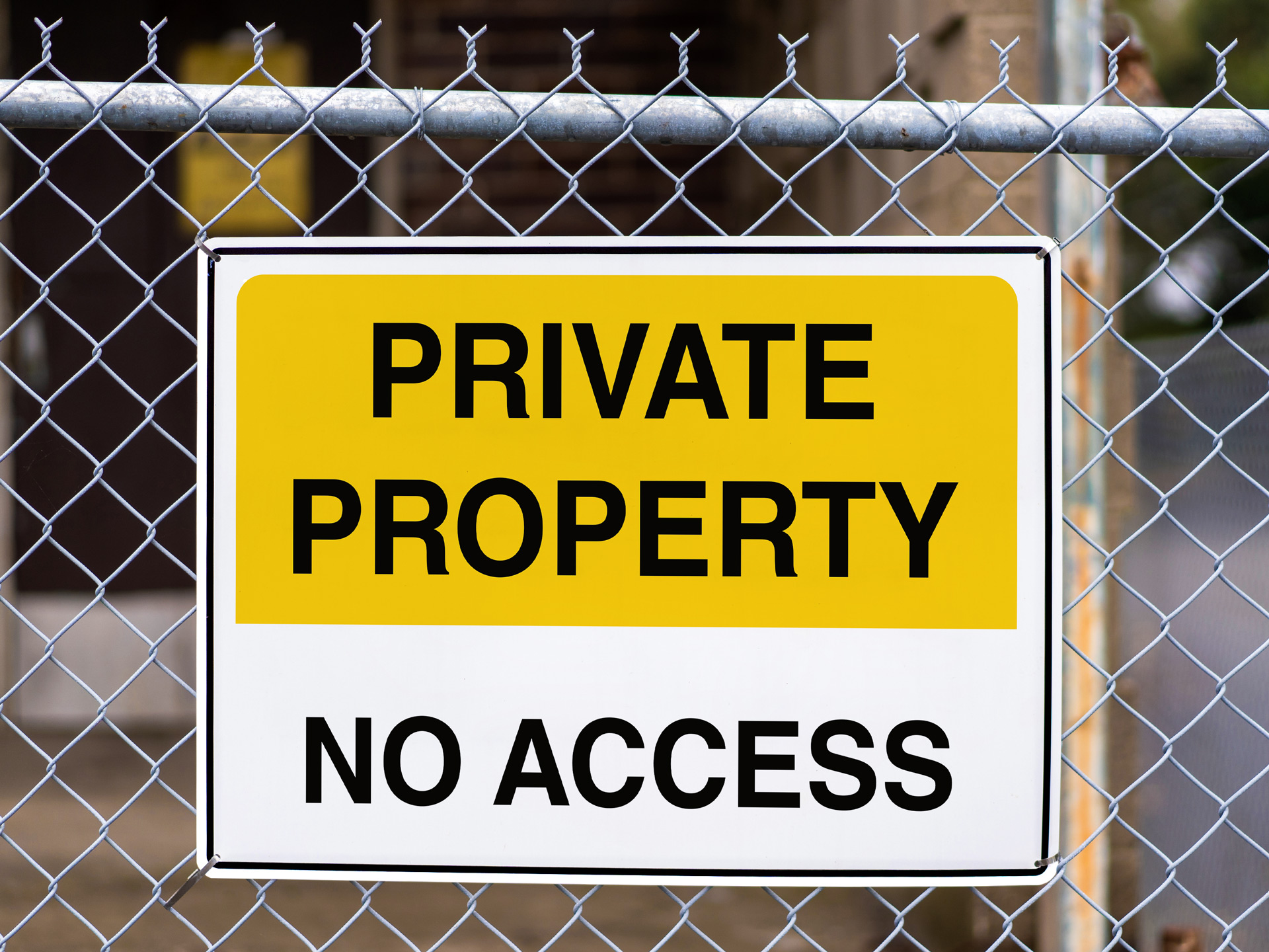 private property aluminum sign attached to a fence