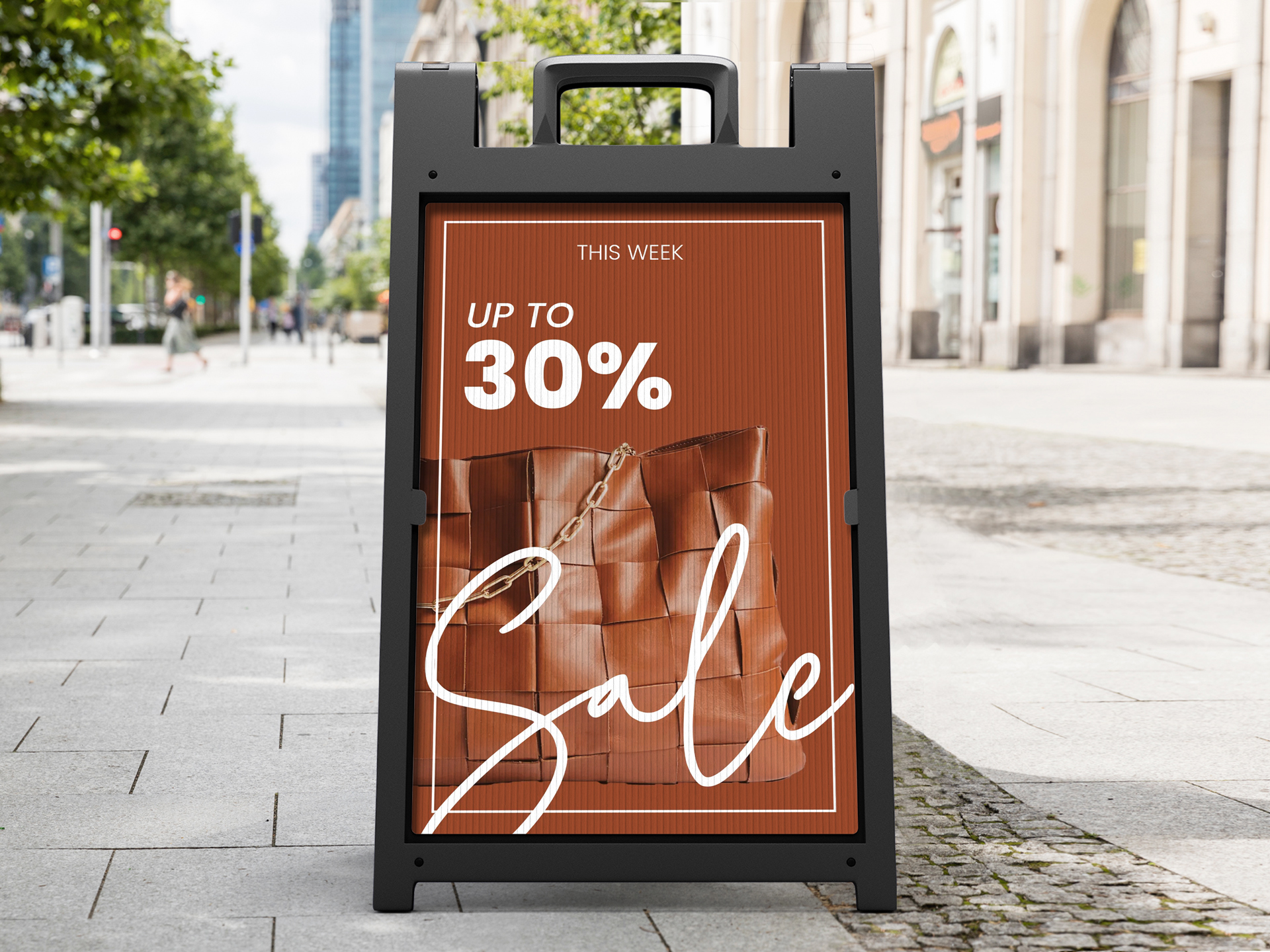 Retail sandwich board sign displaying a sale poster and fashion imagery.