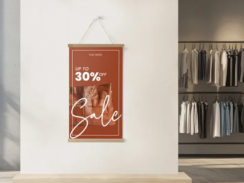 Retail sale poster in magnetic wood frame hanger on boutique wall