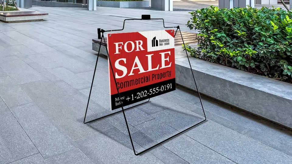 Real estate A-frame sign for sale with contact information.
