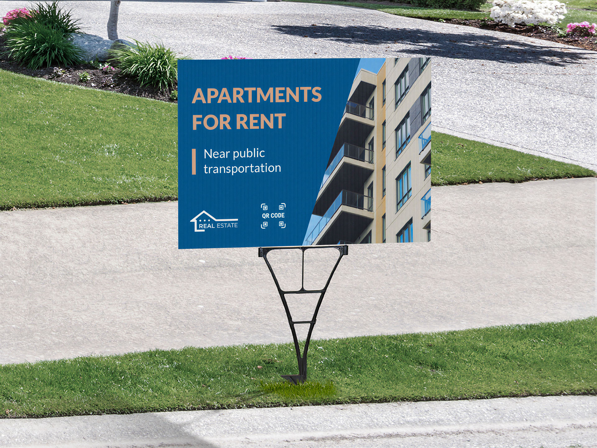 A yard sign with a spider stake setup near the sidewalk telling passersby about apartments for rent in the area.