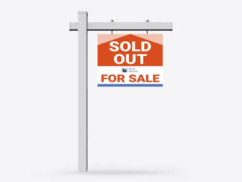 Informative real estate sign notifying passersby that the property has been sold