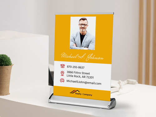 Yellow tabletop retractable banner featuring the realtor's image and the company's name.