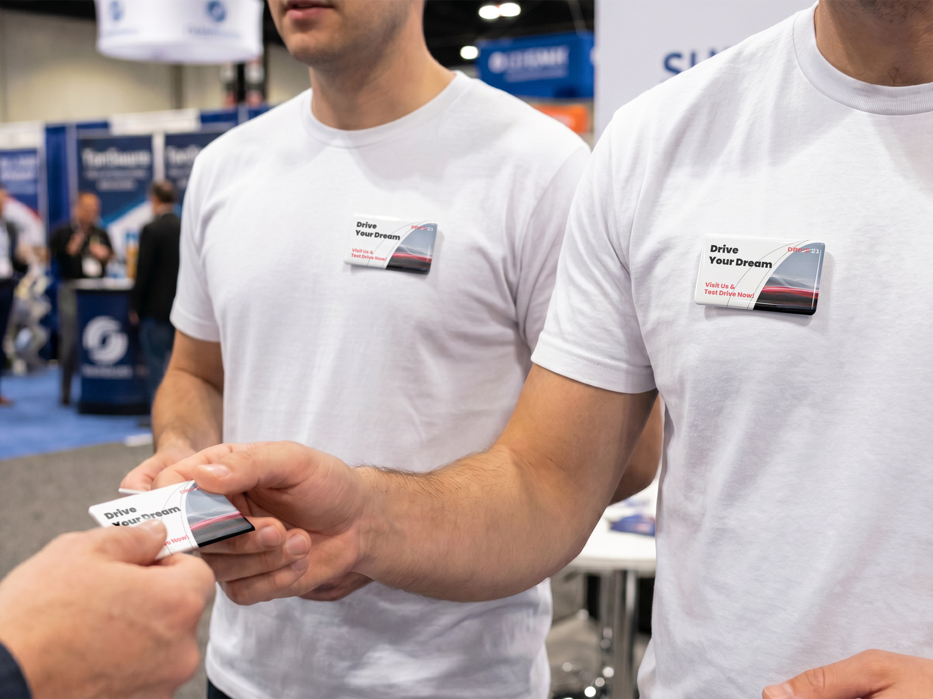 trade show staff wearing company branding custom pinback buttons