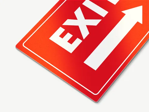Reflective aluminum exit sign with bold white lettering and arrow on a bright red background, designed for high visibility in low-light conditions.