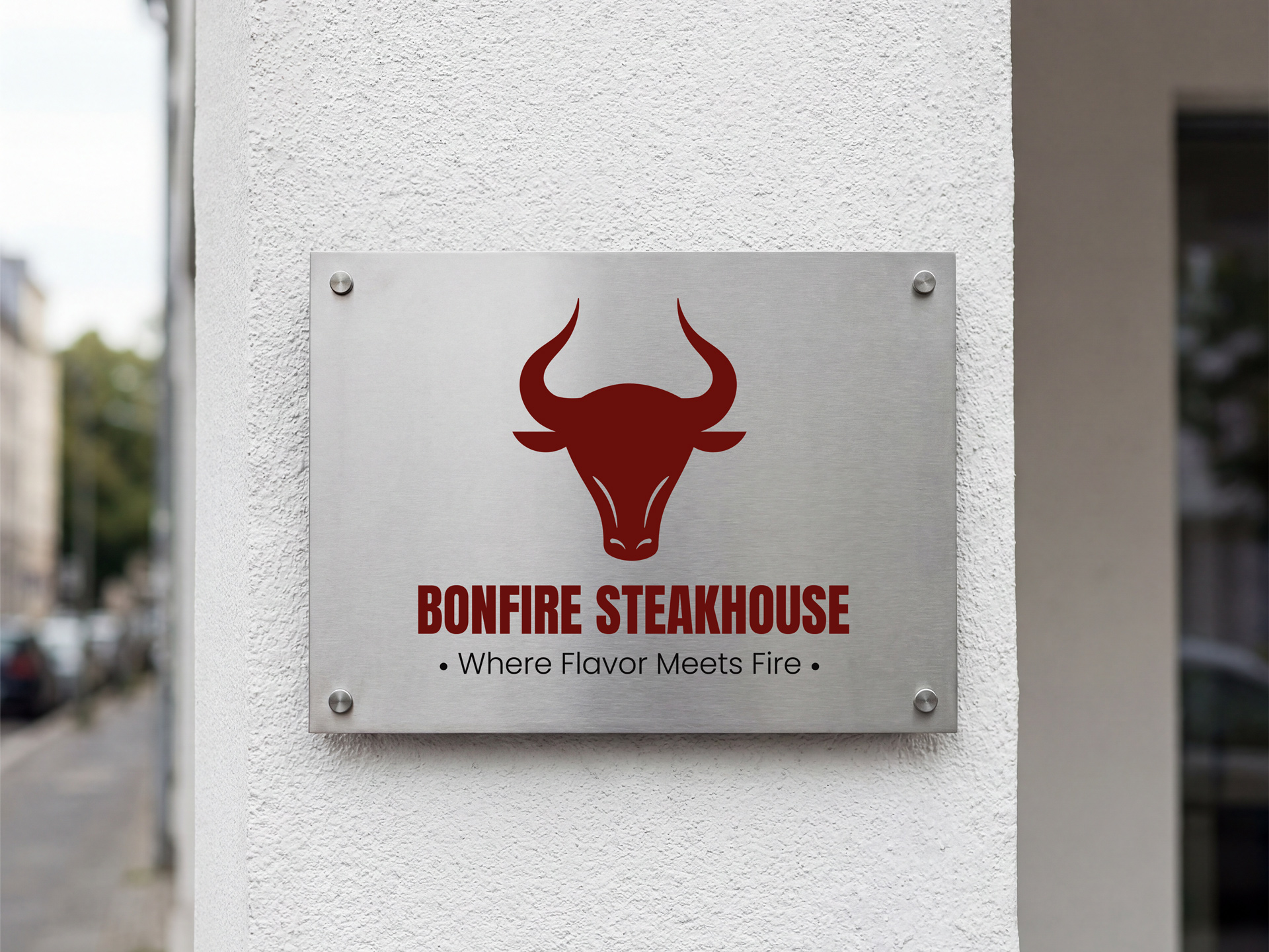Brushed metal signage printed with a steakhouse logo and design.