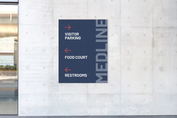 Wayfinding plastic signs pointing to visitor parking, food court, and restrooms.